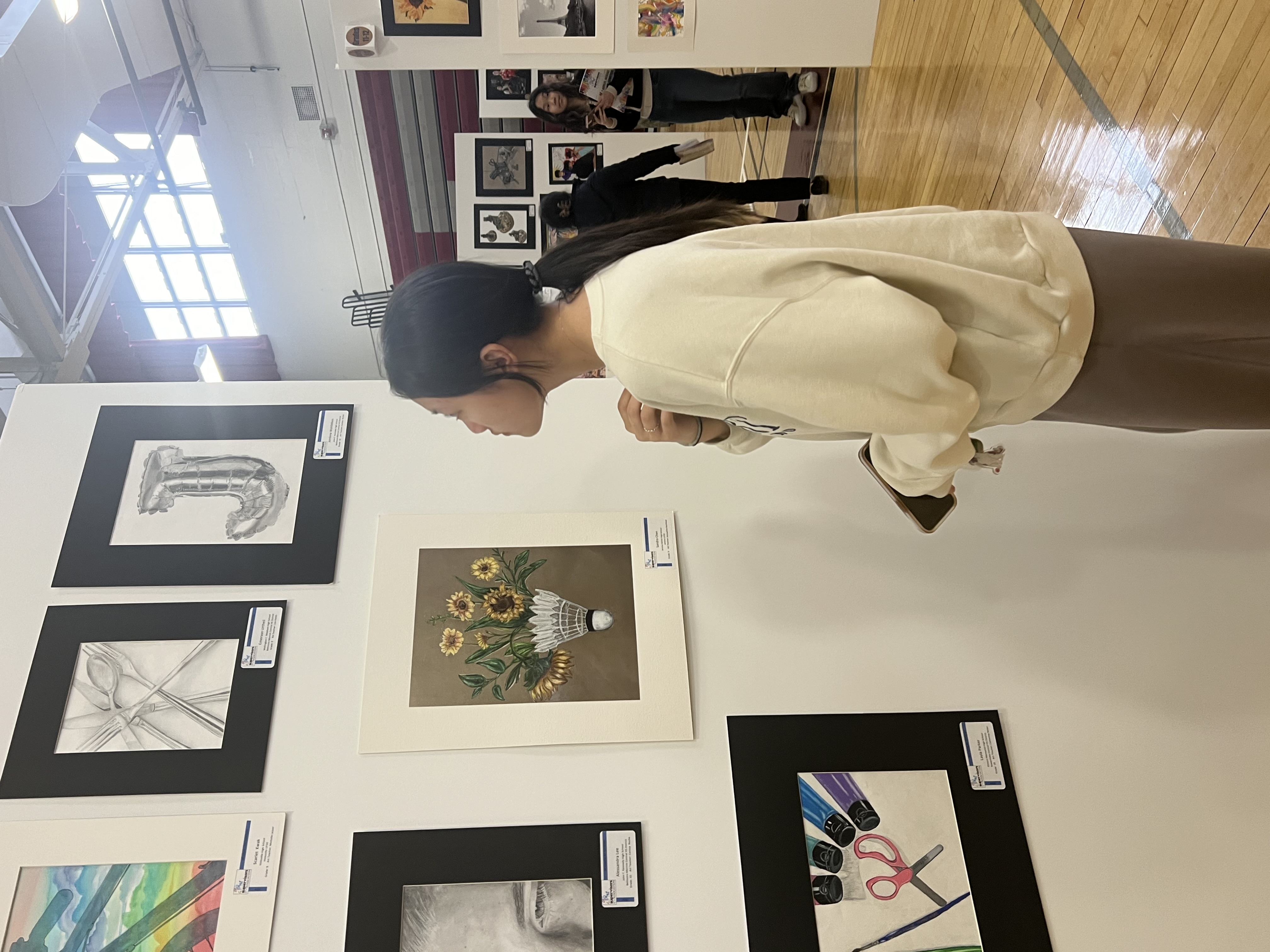 Sandra looking at art displayed at an exhibit