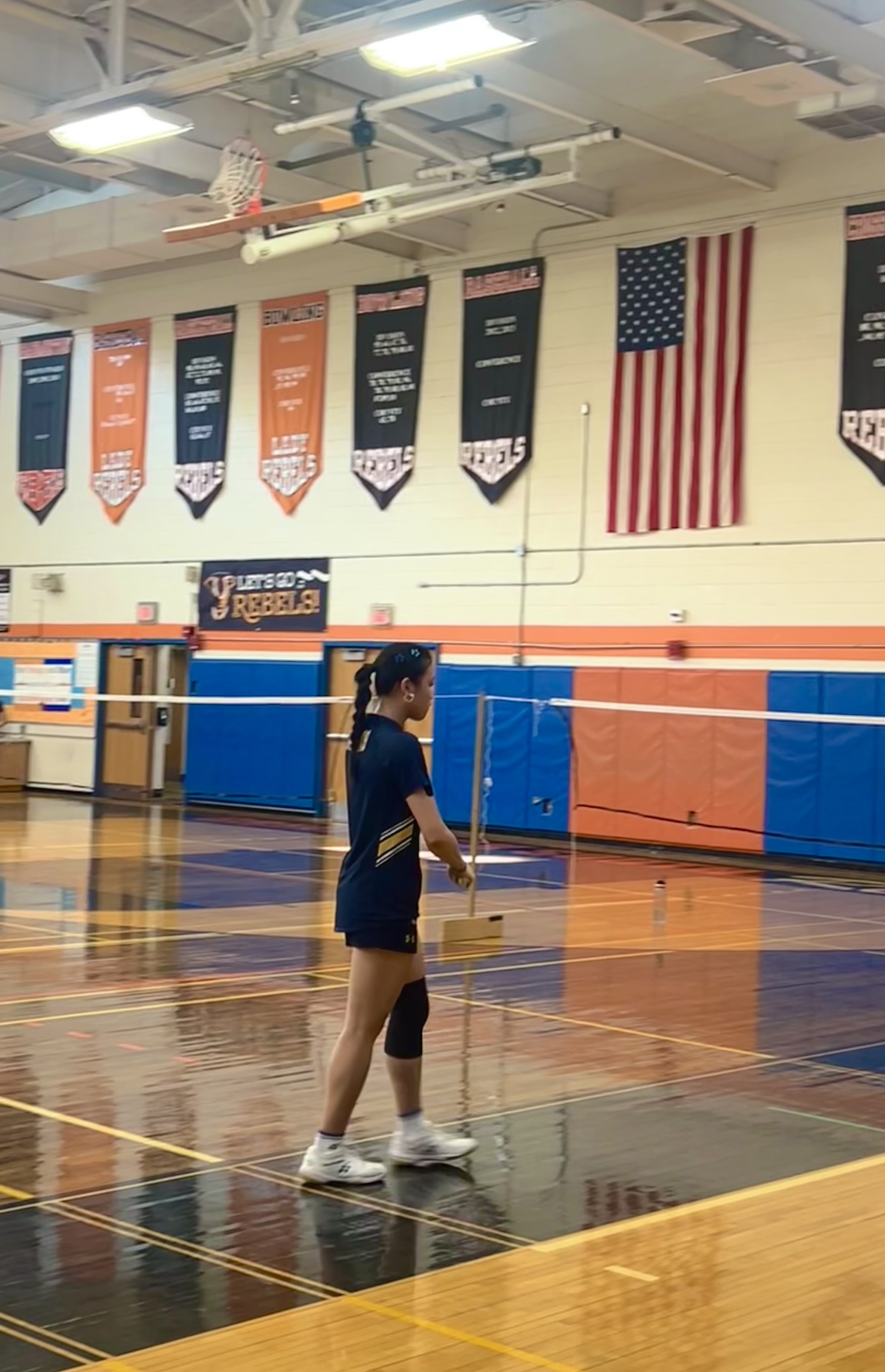 Sandra playing badminton in a gym